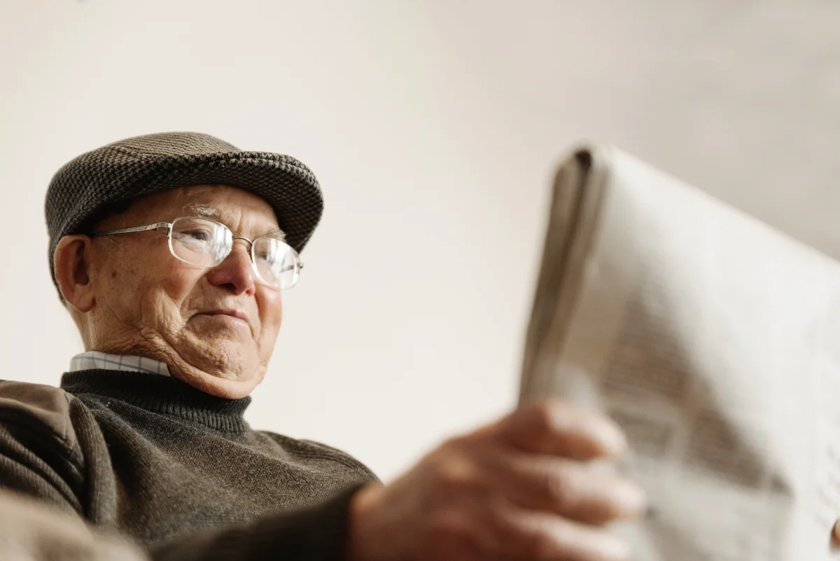 elderly man reading the newspaper
