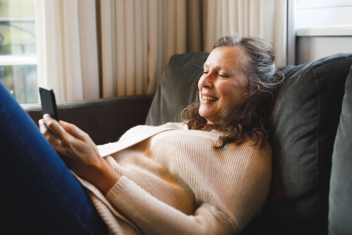 Happy senior woman relaxing in her living room