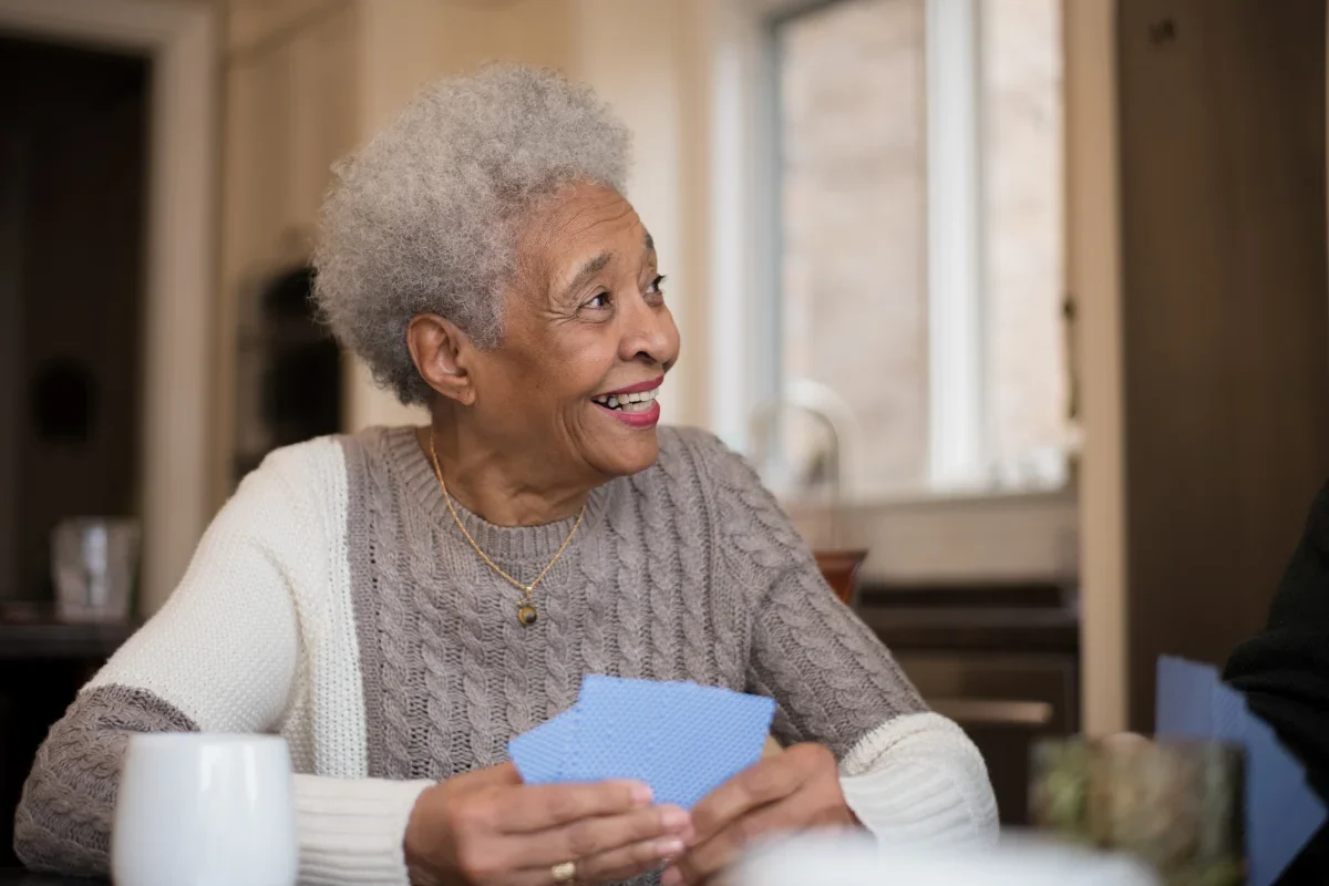 senior woman playing cards in the activity room