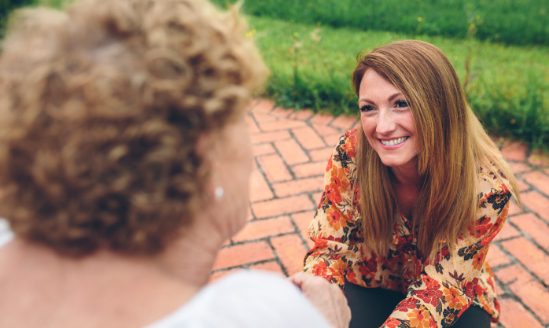 Senior woman speaking with her daughter.