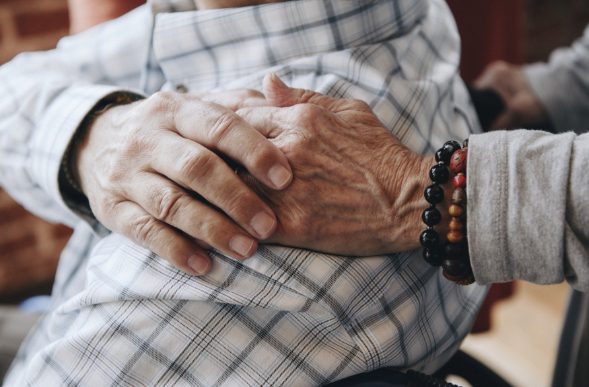 Elderly couple holding hands.