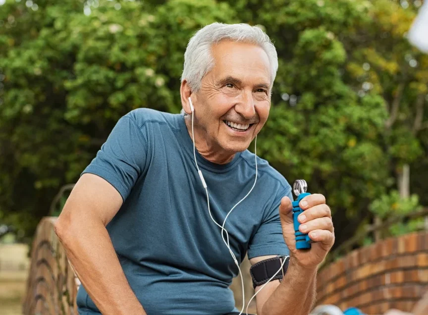 older man using hand gripper to exercise