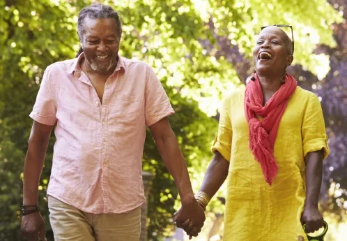 senior couple walking dog on walking trails