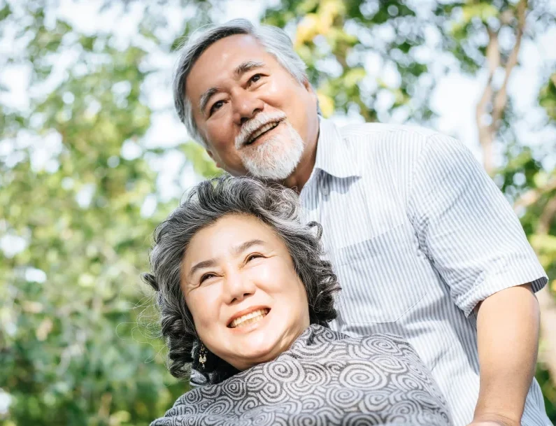 senior man caring for disabled wife in wheelchair