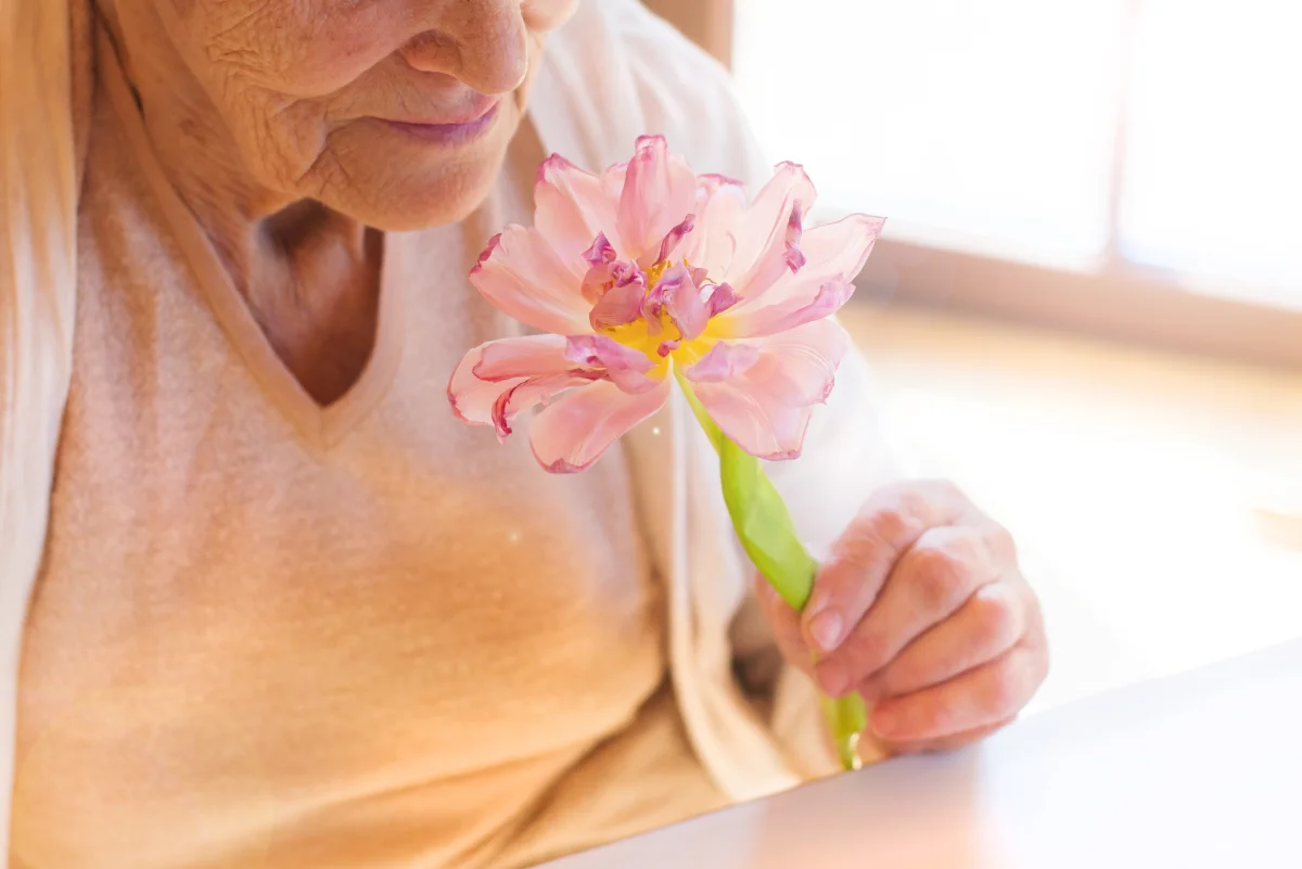 senior woman smelling the flowers