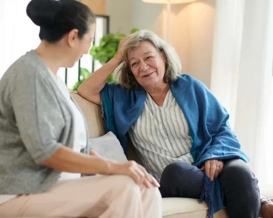 friend visiting resident at senior living memory care facility