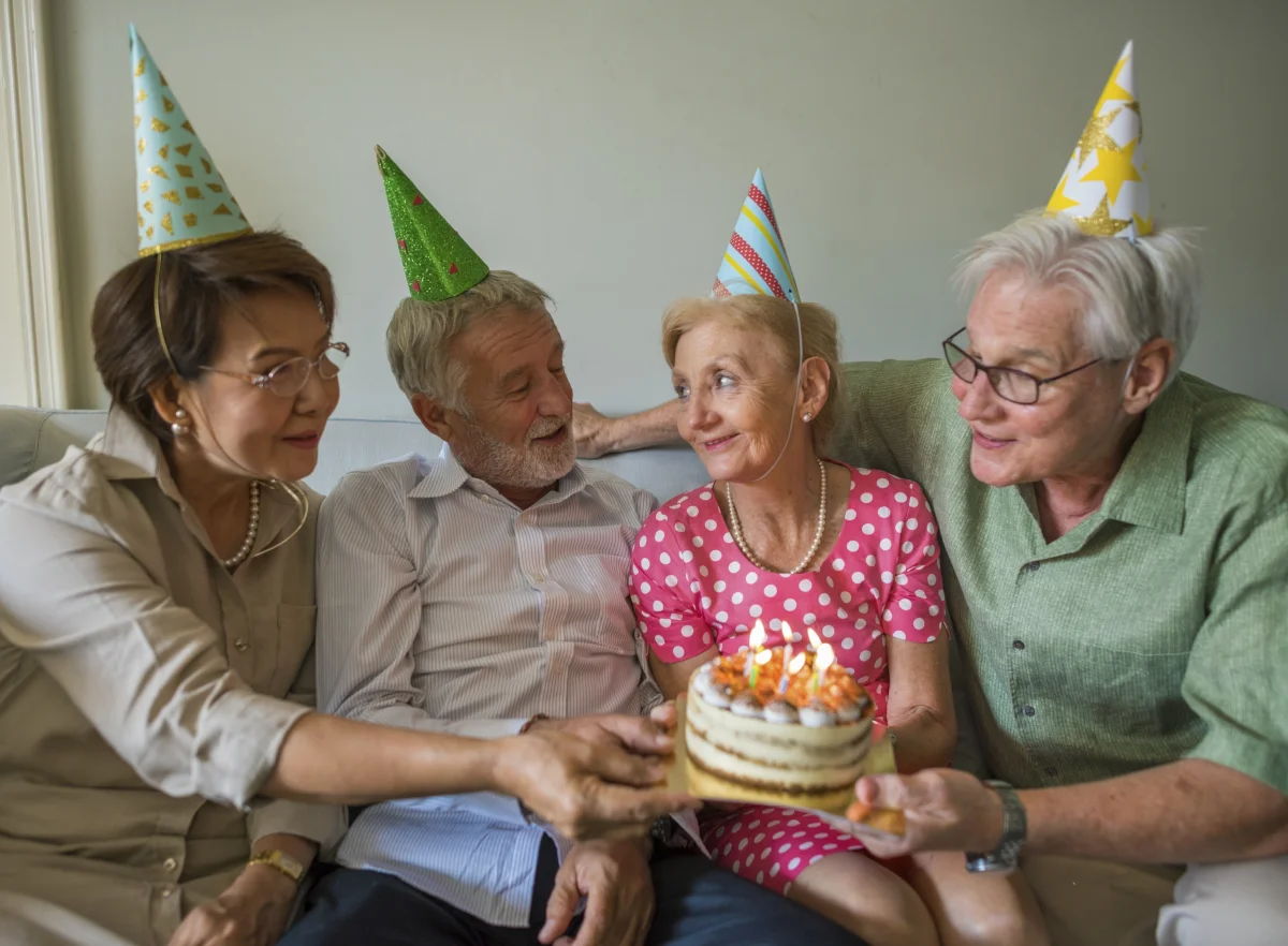 seniors celebrating a birthday with cake