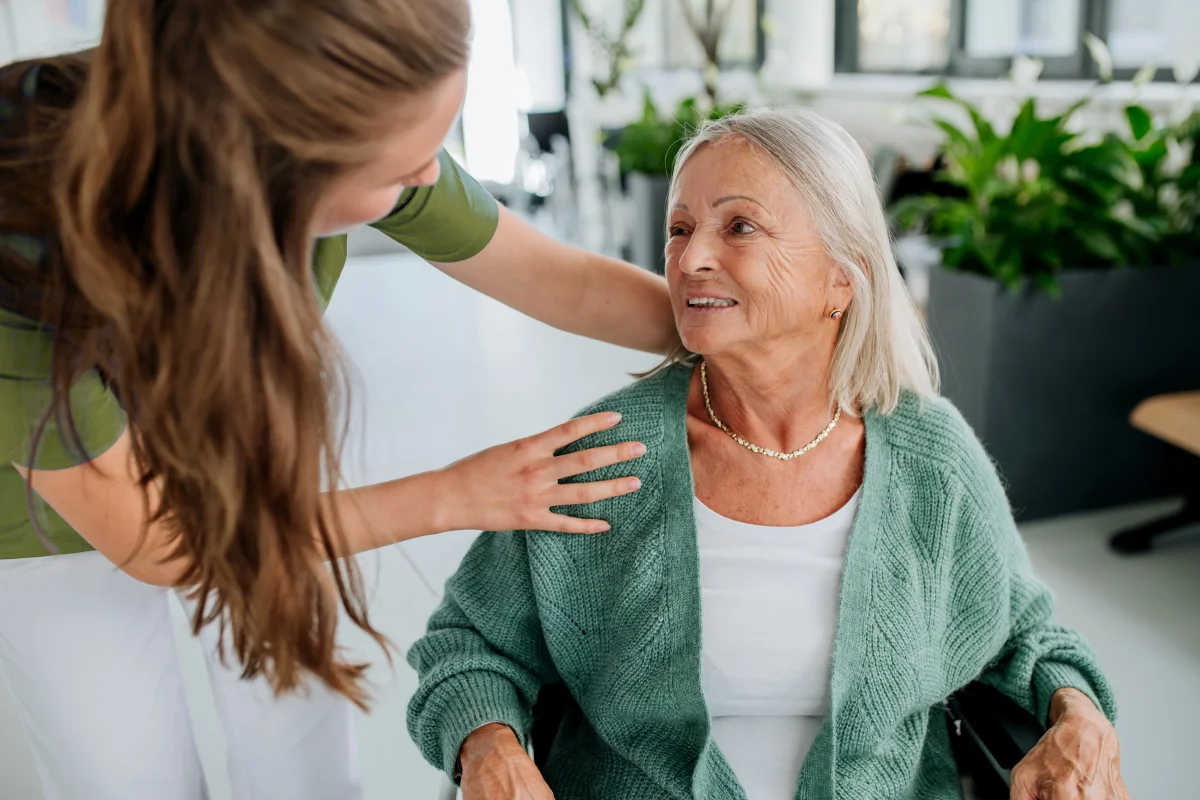 young woman doctor taking care of senior woman