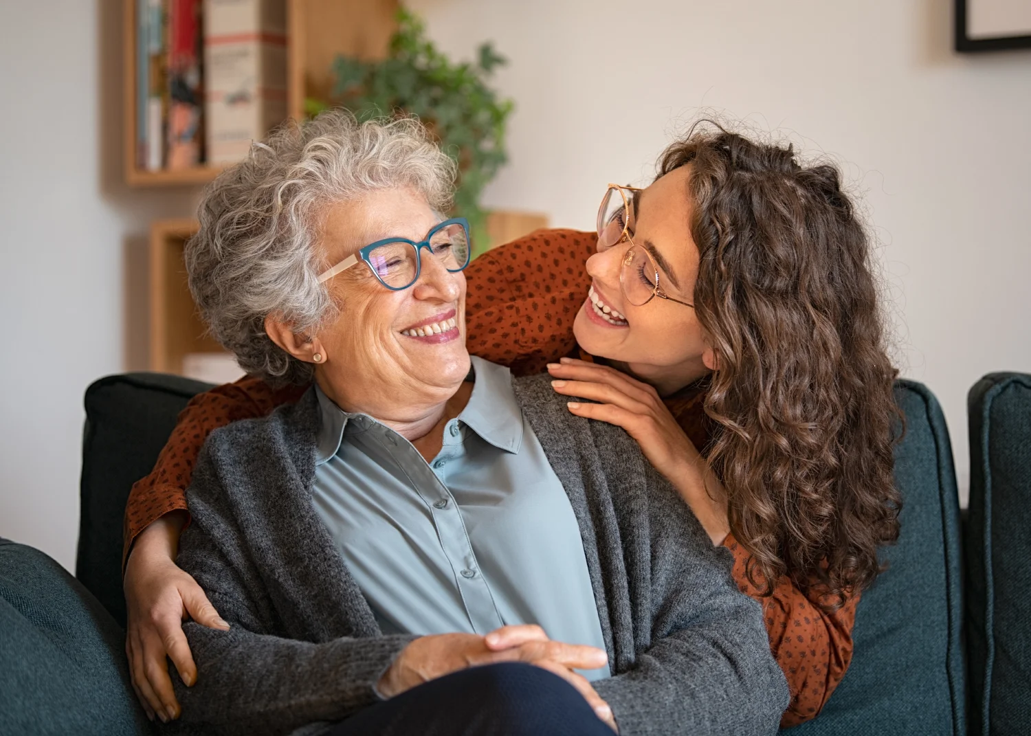 Grandmother and granddaughter laughing and embracing.